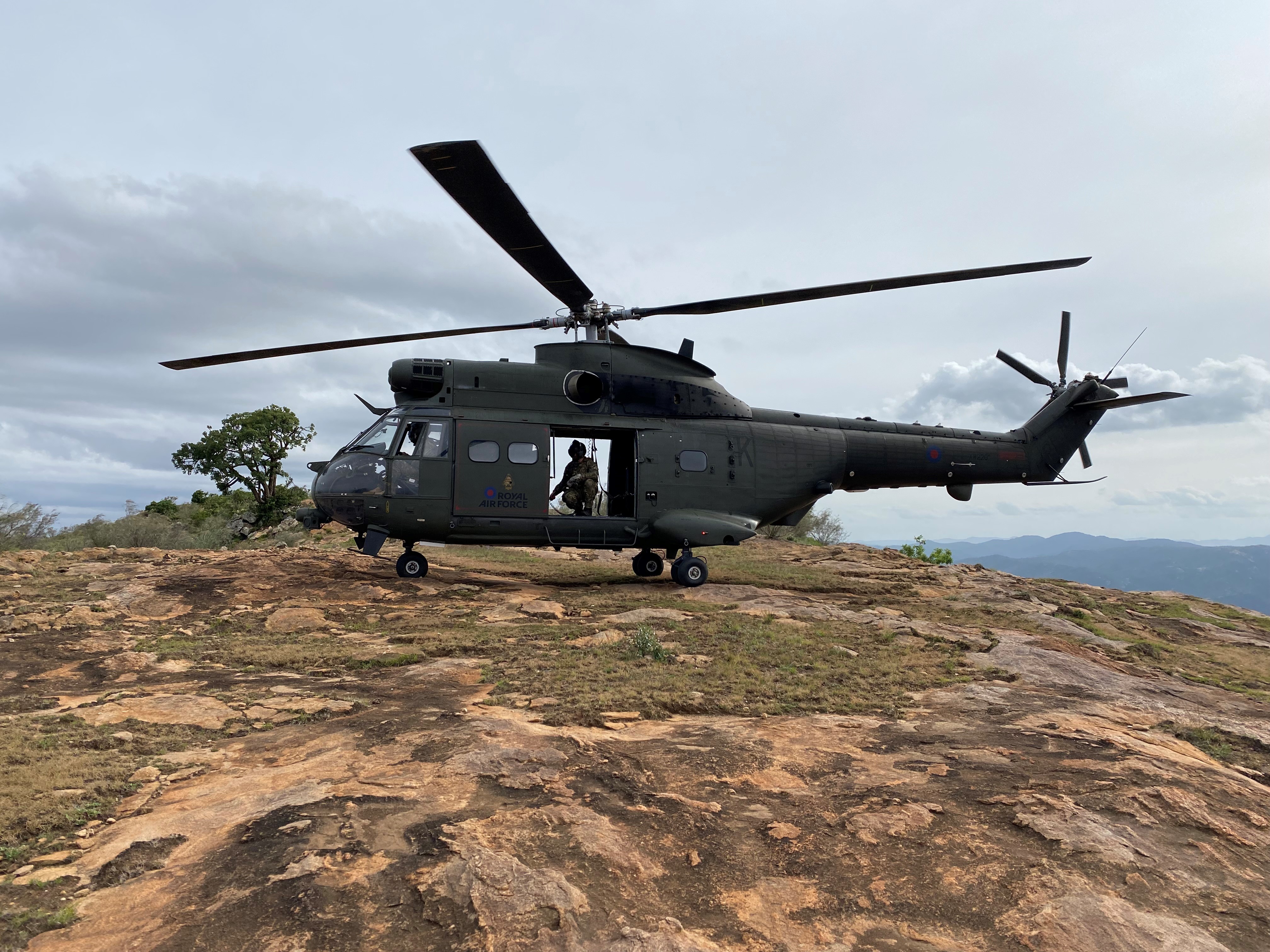A Puma helicopter perches on top of a mountain in Kenya